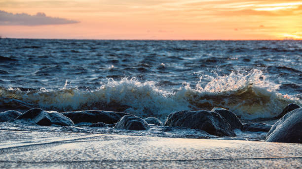 istock Rocky autumn beach with waves crashing on the rocks 680141860