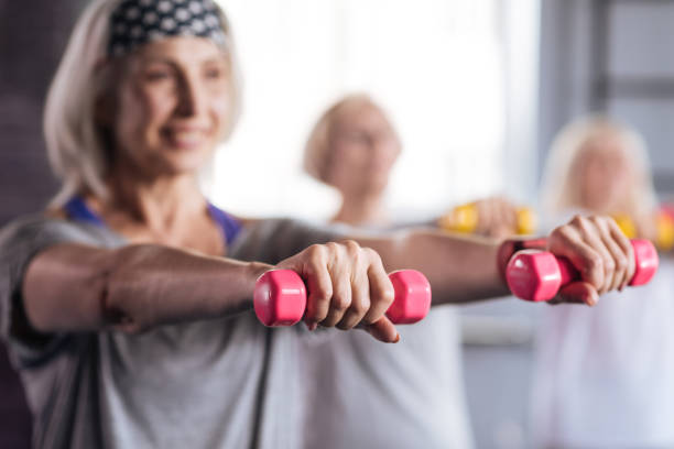 istock Selective focus of pink rubber dumbbells being in use 680144386