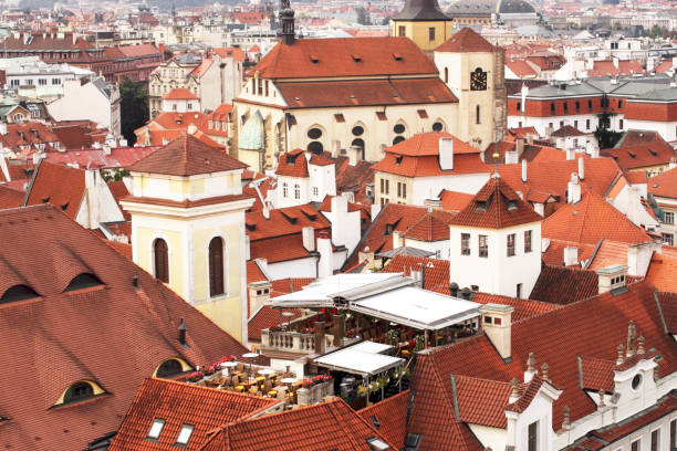 A morning View over part of the many red tile roofs in Prague. Photographed from the Astronomical Clock Tower on Stare Mesto, one early morning. Prague. Europe