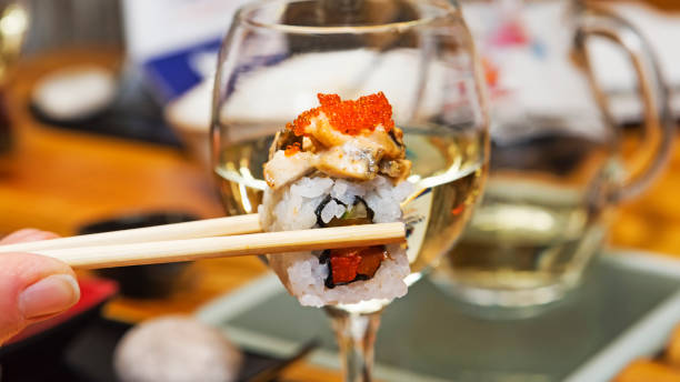 istock Tasty sushi shown using Japanese chopsticks 680144714