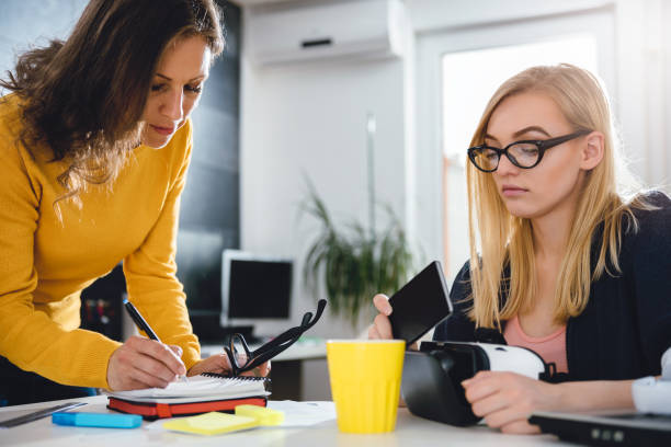 istock Two business woman working together at the office 680145278