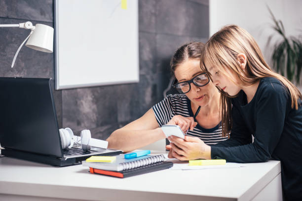 istock Mother and daughter using smart phone 680147594