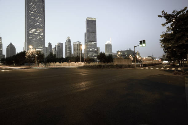 istock Empty road floor surface with modern city landmark buildings of night scene 680148708