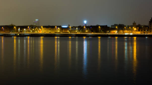 istock summer night city light reflections over water 680151516