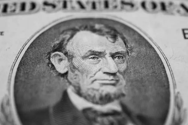 Photo of background of the money, five dollar bills front side. background of dollars, close up, President Abraham Lincoln on the dollar bill