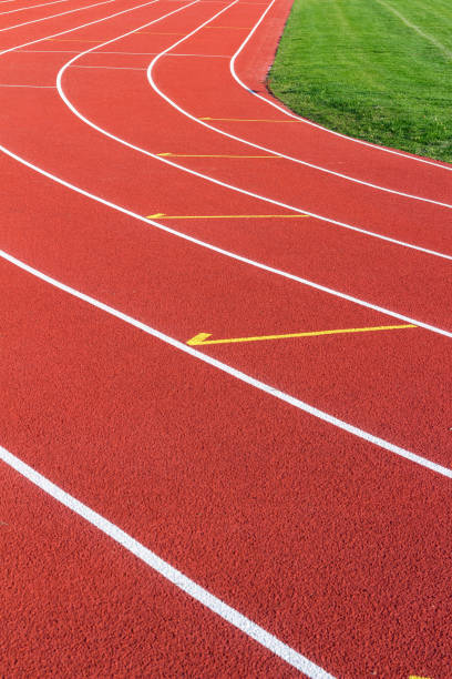 istock Red running track and white lanes on sport stadium 680166292