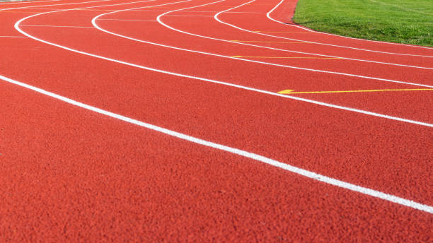 istock Red running track and white lanes on sport stadium 680166350