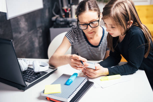 istock Mother and daughter using smart phone 680176422