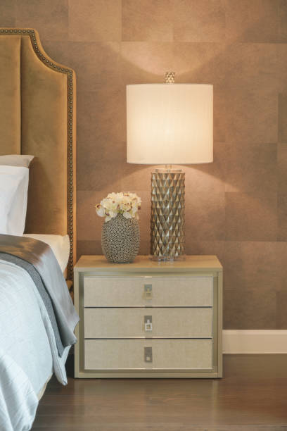 istock Luxury style reading lamp and flower jar setting on beautiful bedside table next to bed 680178476