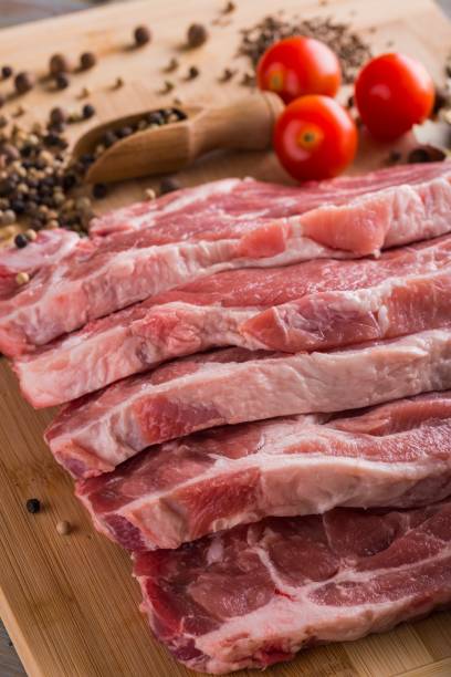 istock Several slices of neck pork steak with spice and tomatoes 680185520