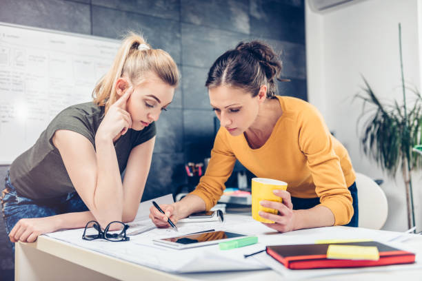 istock Two business woman checking blueprints 680185538