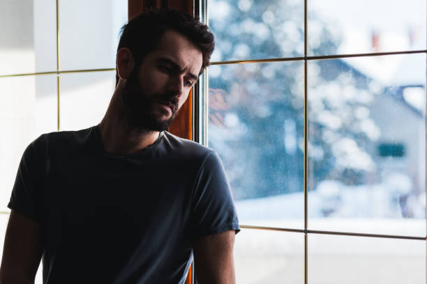 istock Young sad mad standing by the window 680188488