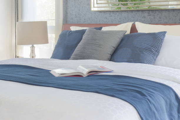 istock Book on bed with blue color scheme bedding bedroom interior 680191832