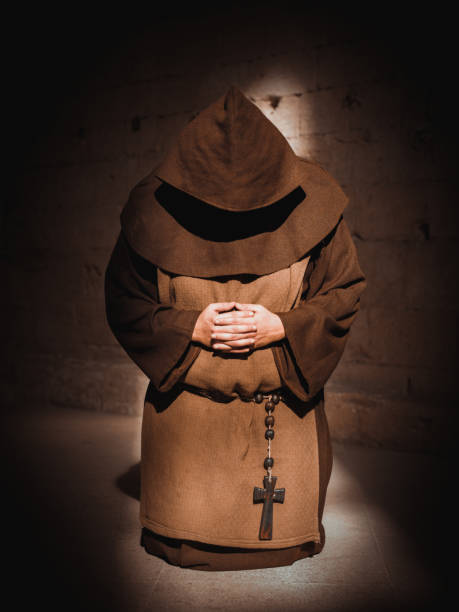 istock Monk praying on his knees in cathedral 680194728