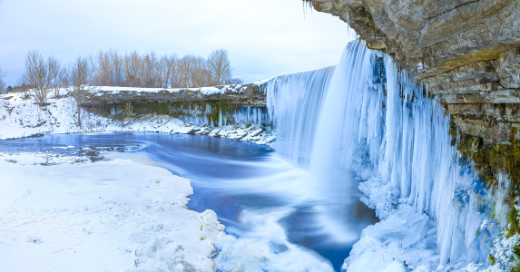 Winter ice covered and snowy waterfall, amazing site in Estonia