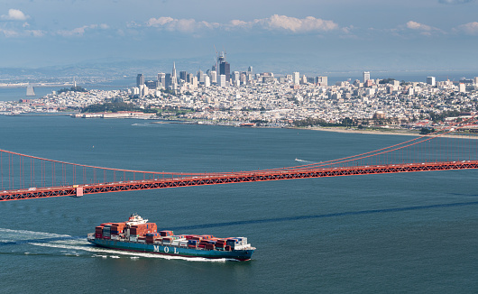 SAN FRANCISCO - APRIL 19: MOL container ship enters San Francisco Bay under Golden Gate Bridge on April 19, 2017. The MOL Guardian is 275m long.