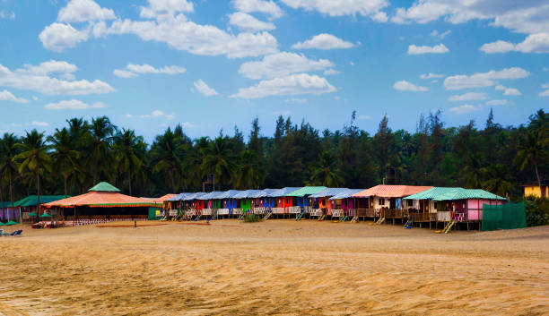 Colorful huts in Agonda beach with palm trees background in Goa, India Colorful huts in Agonda beach with palm trees in Goa, India palolem beach stock pictures, royalty-free photos & images