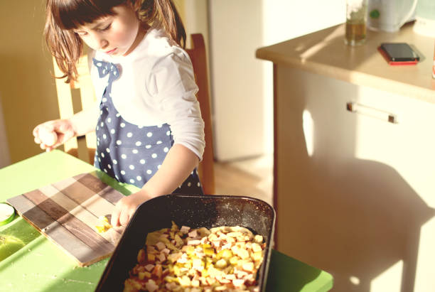 istock Happy little girl chef in kitchen 680199650