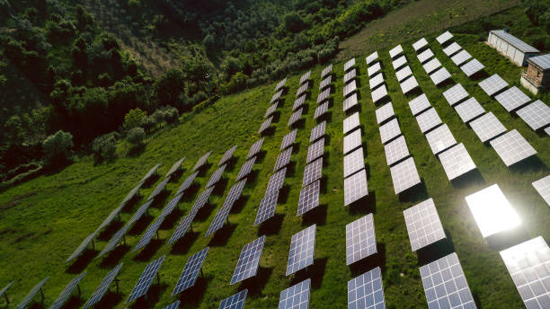 istock Fields of solar panels on the green hills in spring 680200284