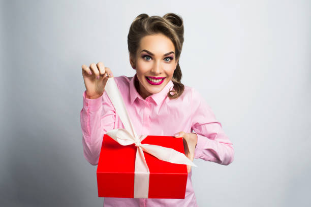 istock Happy woman unpacks gift 680220382