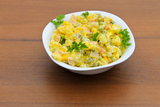 istock Russian traditional salad olivier on wooden table 680221242