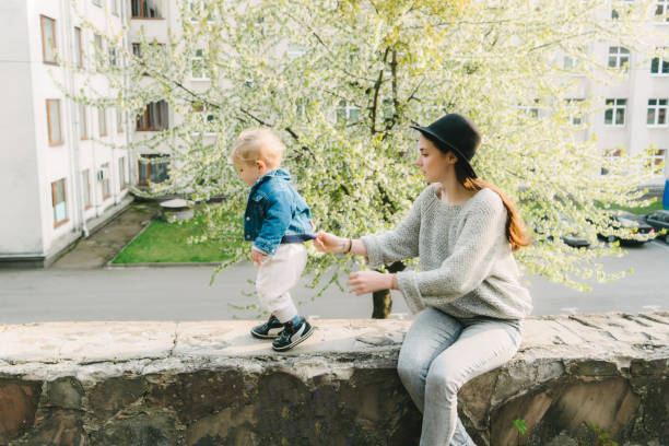 istock Mother walking with child in the park 680226640