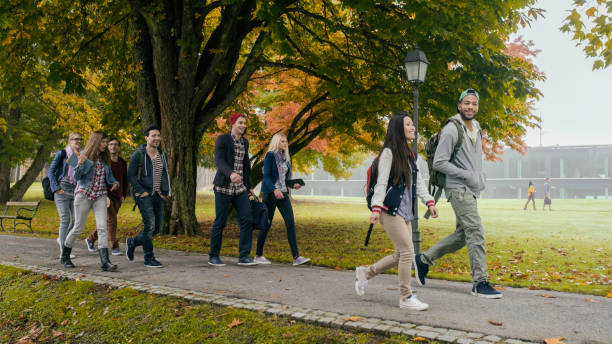 istock Group of students walking through the park 680248534