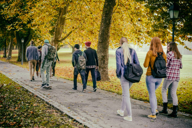 istock Students walking through the park in autumn 680248802