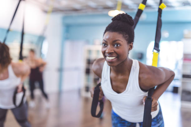 istock Multi-ethnic group of women doing TRX workout 680250934