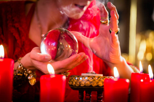 istock Soothsayer in Seance with Crystal ball and smoke 680256100