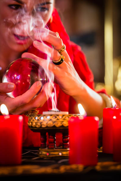 istock Soothsayer in Seance with Crystal ball and smoke 680258588