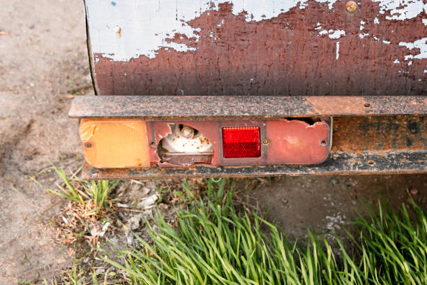 istock Retro vintage car back side with broken back light or taillight and grass beneath. Retro color effect 680271524