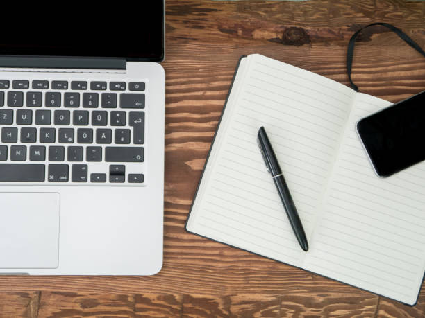 istock Wooden Desk with Laptop, notebook and smartphone. Top-view 680273950