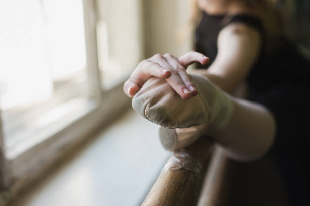 istock Attractive ballerina warming up in ballet class 680280442