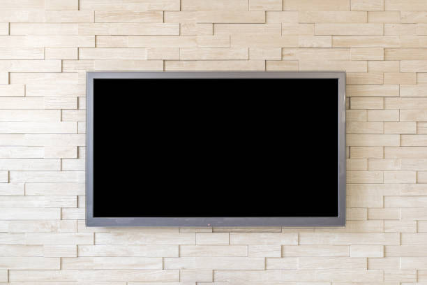 istock TV display on modern brick wall background with black screen 680283038