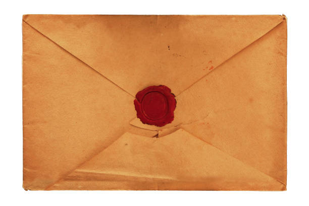Old vintage yellow paper blank mailing envelope with retro styled red wax seal, close up, elevated top view