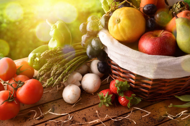 istock Fruits and vegetables on table and crop landscape background elevated 680283612