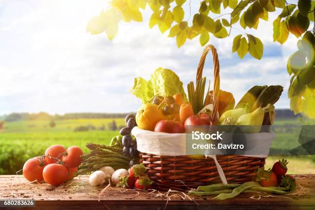 Fruits And Vegetables On Table And Crop Landscape Background Stock Photo - Download Image Now