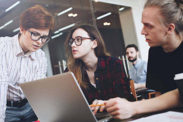 istock Group of young people are working on a new idea. Teamwork in a modern office. Open space, laptops and paperwork 680286364