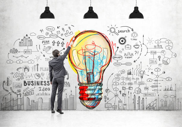 istock Man drawing light bulb and business icons 680286982