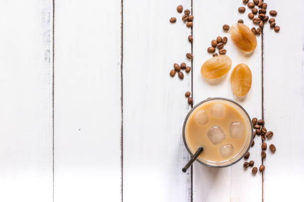 istock coffee ice cubes and beans with latte on white desk background top view 680287202