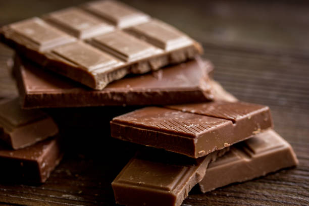 istock black and milk chocolate bars dark wooden table background 680287920