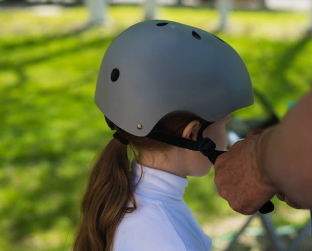 istock Father putting on safety helmet to his daughter 680287988