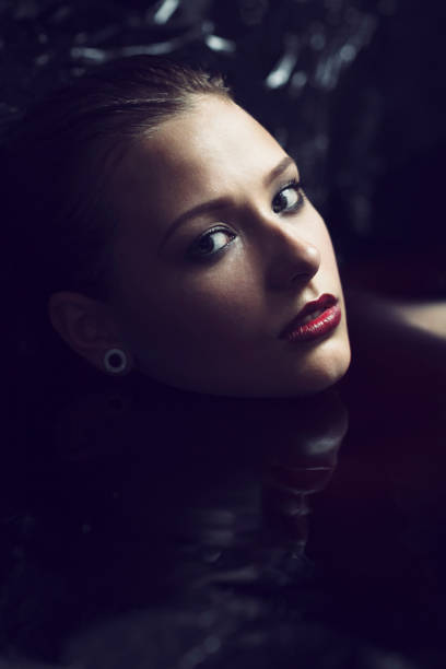 istock Beautiful Woman In Black Water 680303326