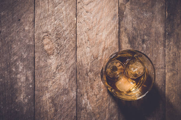 istock Whiskey glass on an old wooden table 680303672