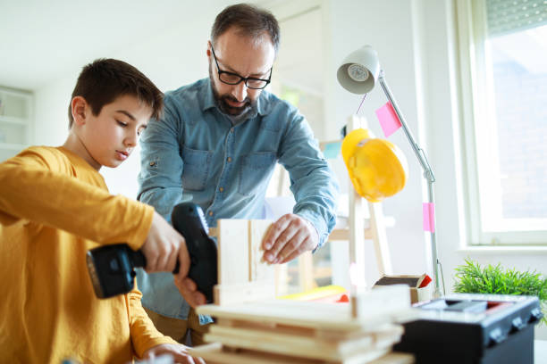 istock Father and son working at home 680304750