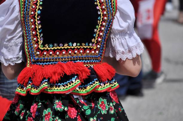 Polish traditional folk costume. Polish heritage. Beautiful, colorful, handmade folk costume. Vest with beads, sequins, ribbons, red fringes and flowery skirt. polish culture stock pictures, royalty-free photos & images
