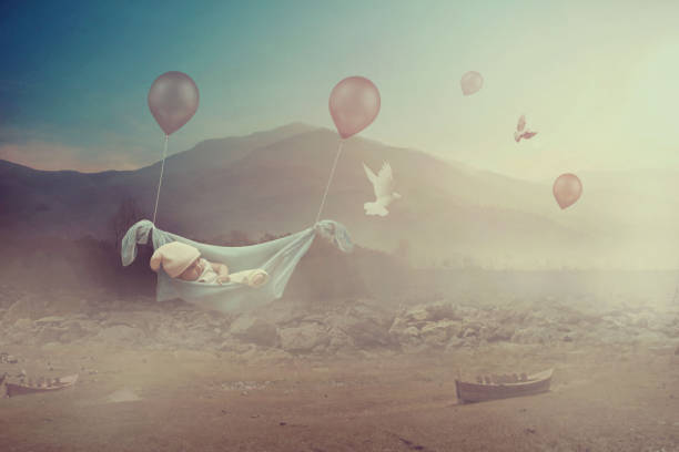 Adorable baby flying with balloons in a valley  - Dreaming