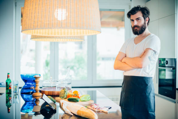 istock Young handsome man preparing healthy food in the kitchen 680323486