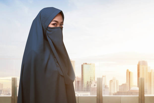 istock Religious asian muslim woman with covered face standing 680334302